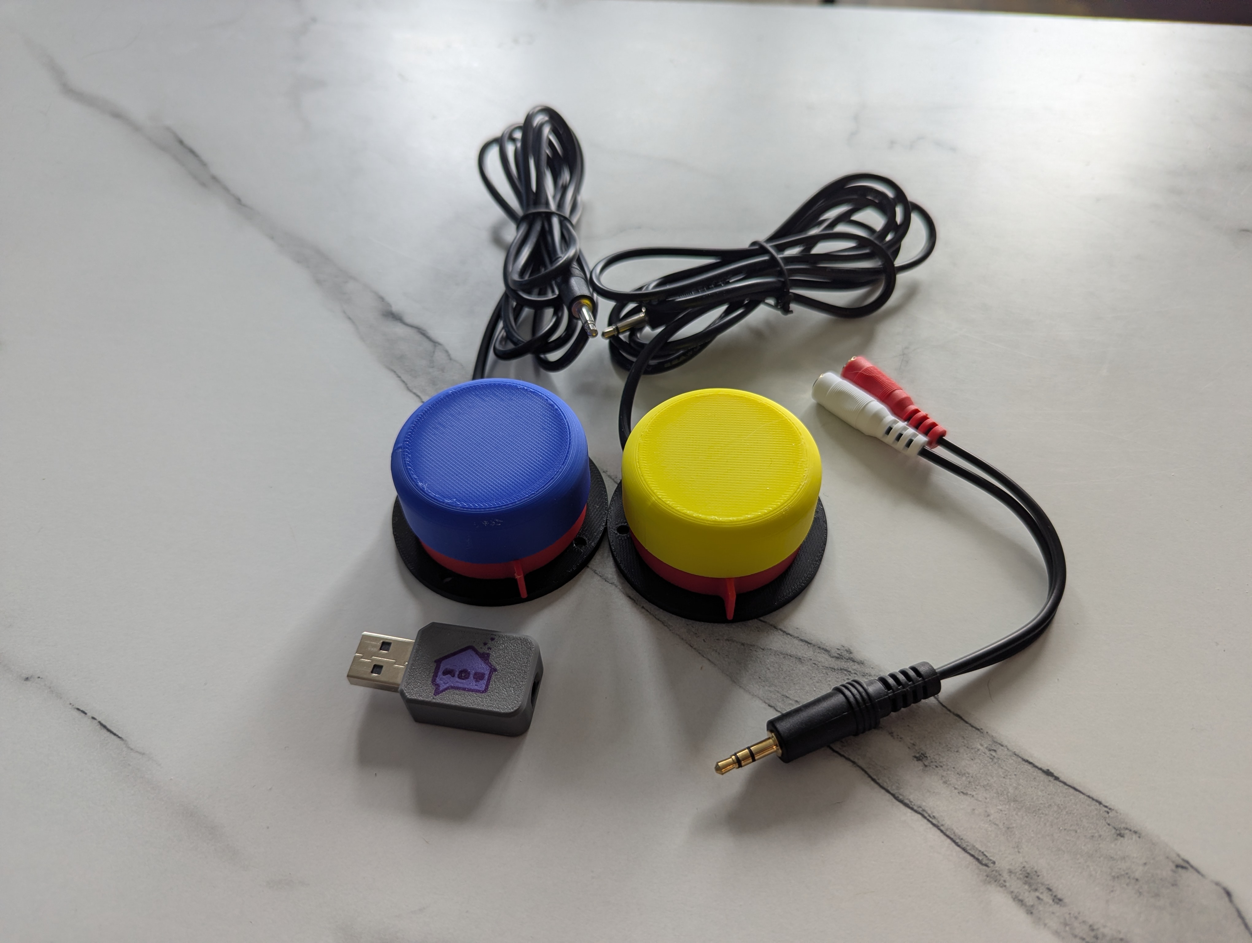 NARBE Foundation 2-Switch Kit contents: two large accessibility switches, USB adapter, 3.5mm splitter cable, and velcro strips